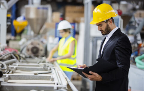 Young quality inspector checking production line